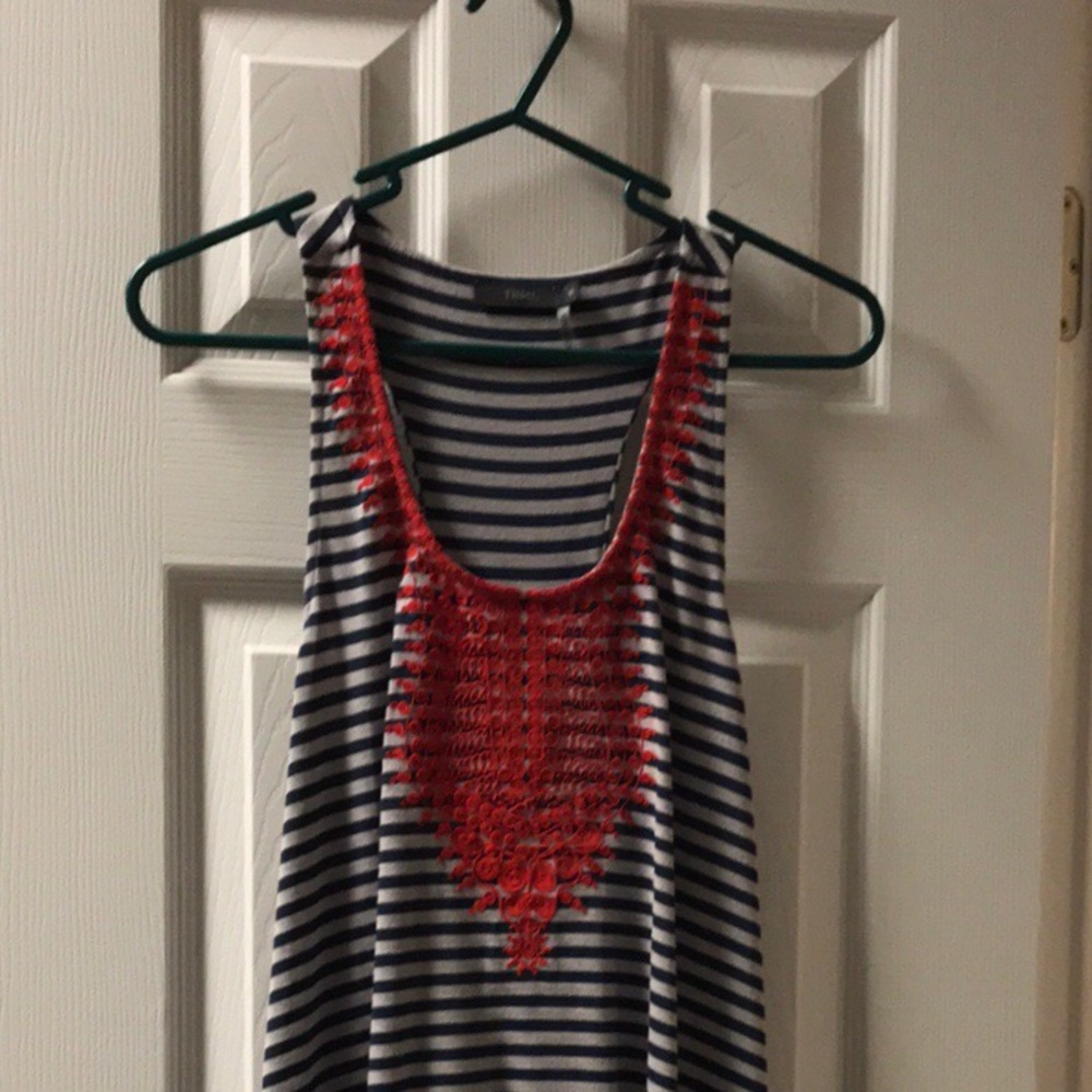 Racer back tank with front embroidered detail.